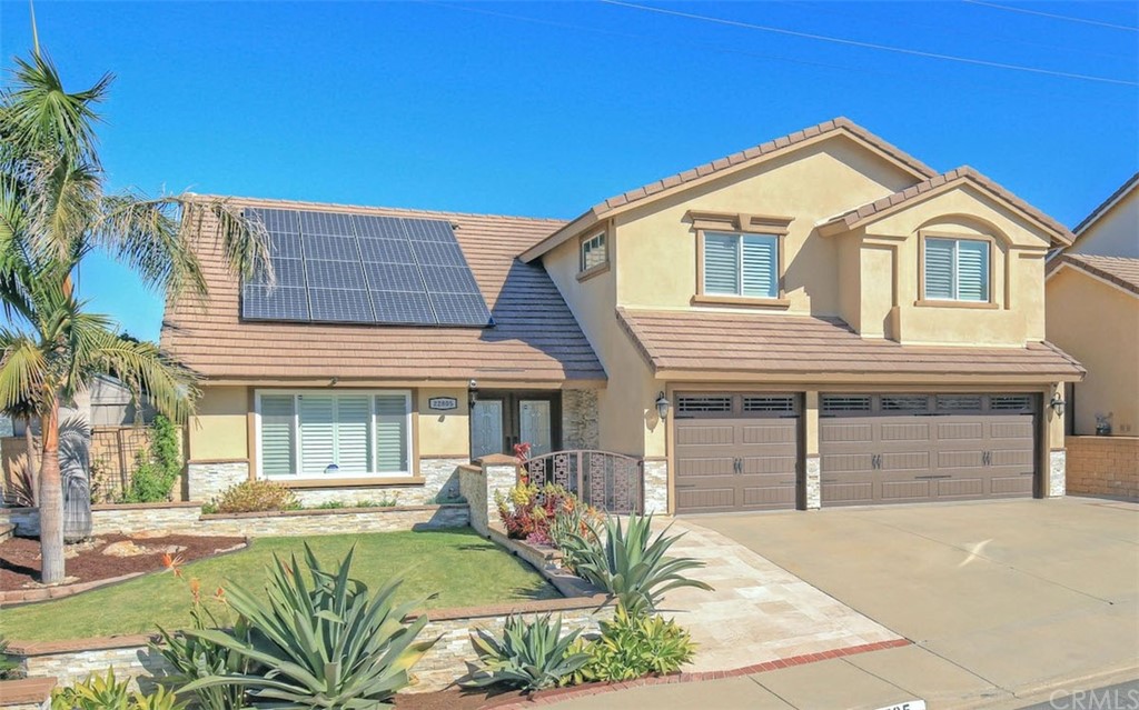 22805 Rio Lobos Road Diamond Bar, CA 91765 - Photo 3 of 50 a front view of a house with a yard and garage