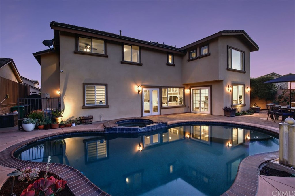 22805 Rio Lobos Road Diamond Bar, CA 91765 - Photo 49 of 50 a front view of a house with swimming pool table and chairs