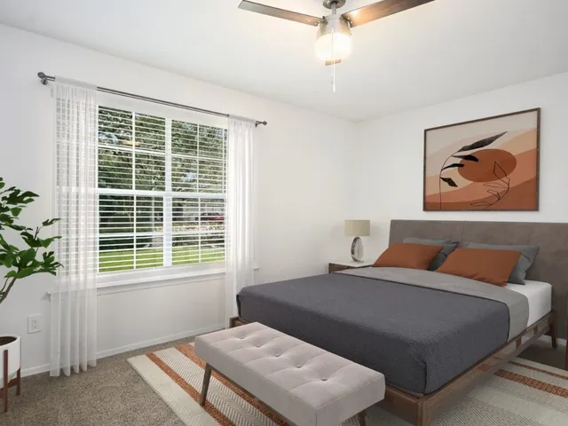 a bedroom with a bed and a window