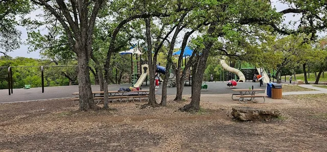 a view of park with bench and trees