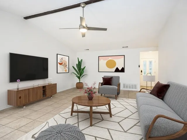 a living room with furniture and a flat screen tv