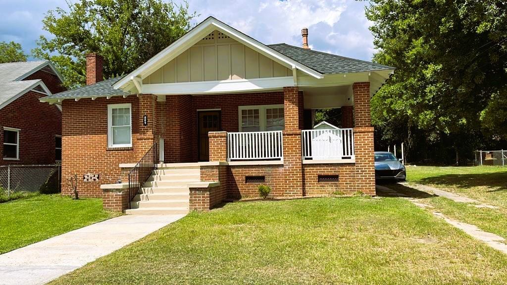 a front view of a house with a yard table and chairs