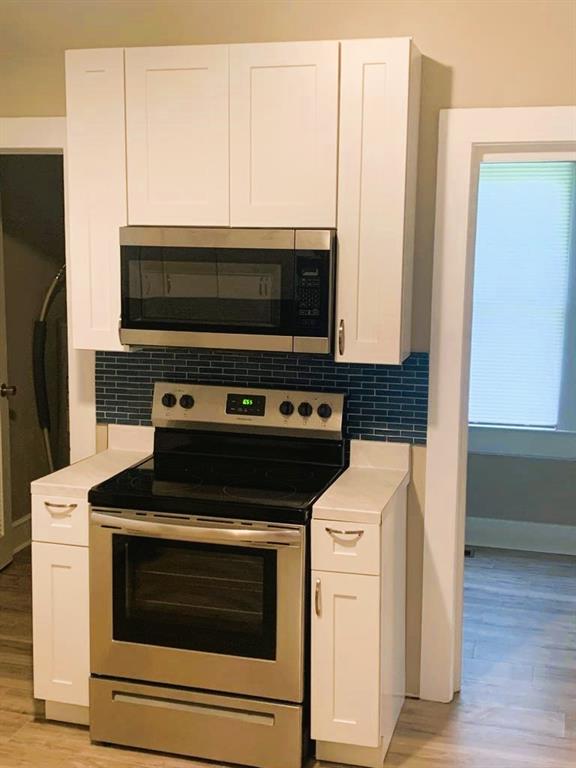 689 Grenada Terrace Macon, GA 31206 - Photo 5 of 9 a kitchen with a stove and a microwave