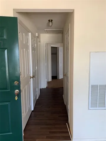 a view of a hallway with wooden floor