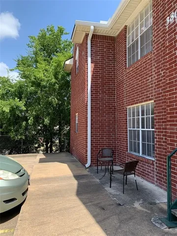 a view of a patio with a table and chairs and potted plants
