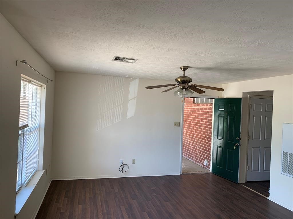 3801 College Main Street, Unit AD Bryan, TX 77801 - Photo 7 of 18 wooden floor in an empty room with a window