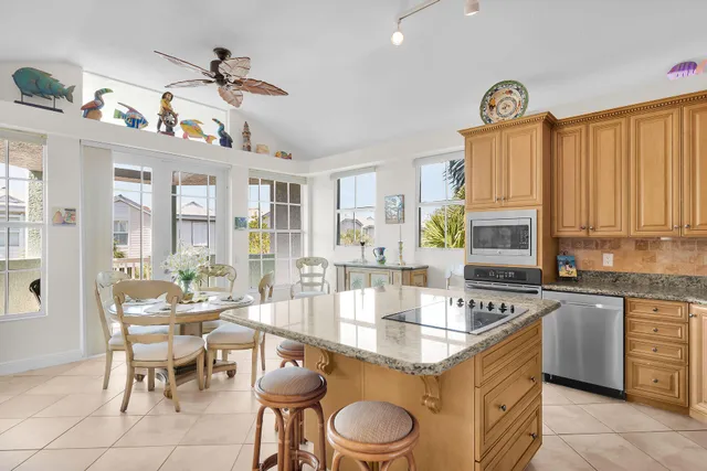 a kitchen with stainless steel appliances granite countertop a sink a stove and a refrigerator