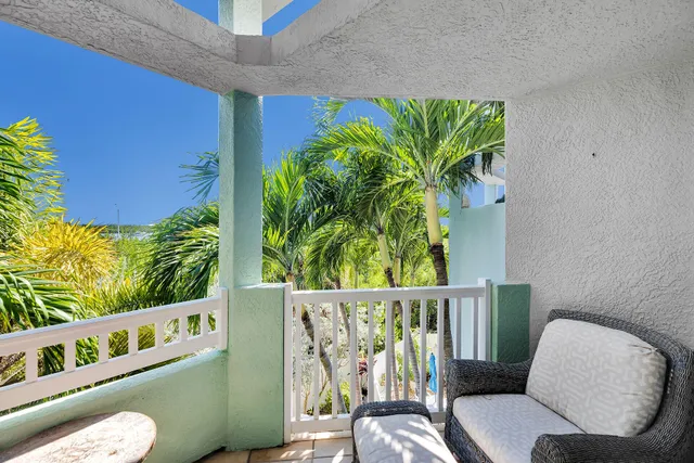 a blue chair sitting in a bedroom next to a window