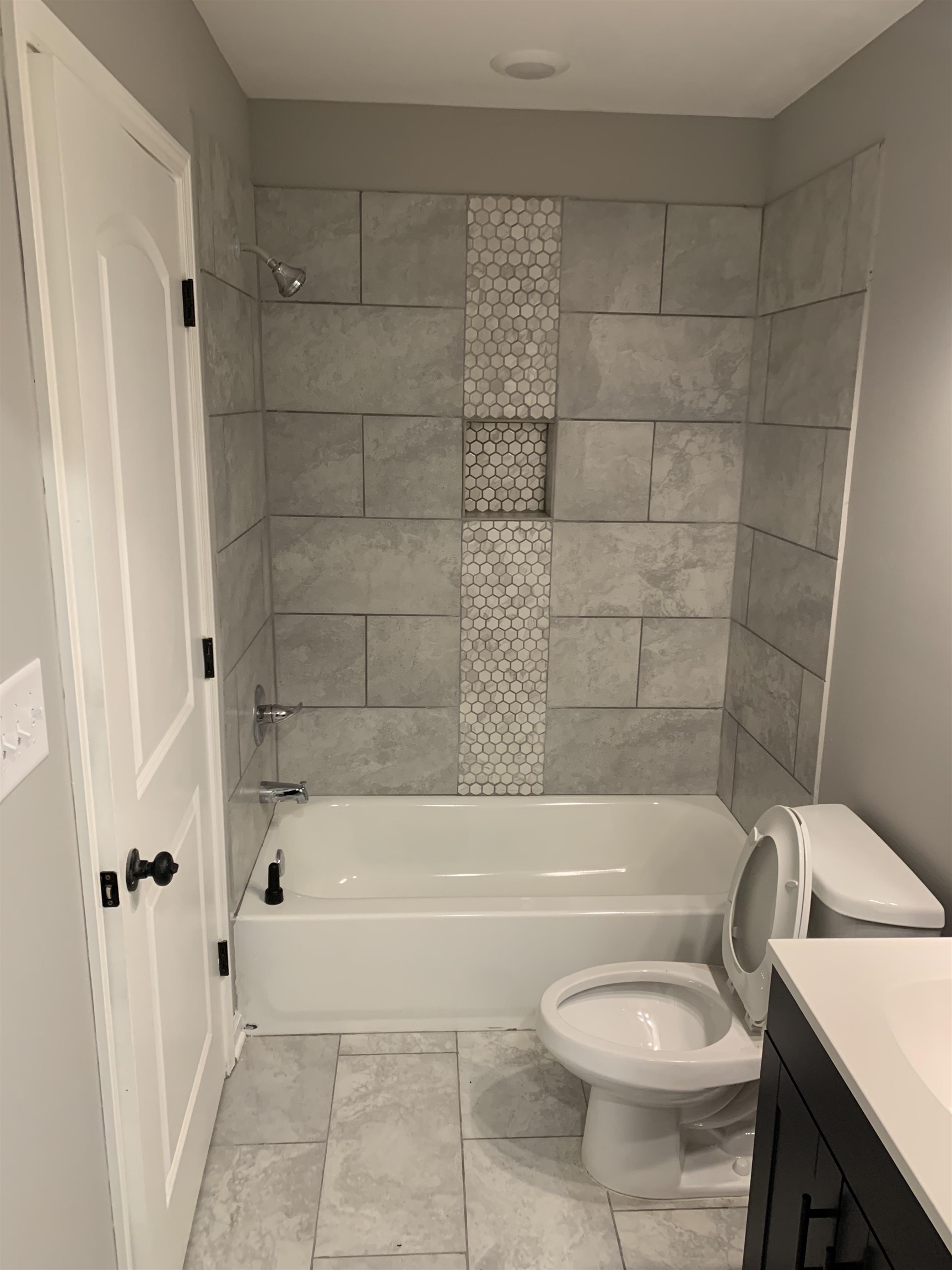 4372 Ryan Street Memphis, TN 38127 - Photo 8 of 9 Full bath with bathing tub / shower combination, vanity, and light marble finish floors