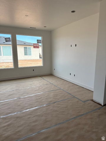 4987 North 970th East Enoch, UT 84721 - Photo 4 of 14 Unfurnished room featuring baseboards and concrete floors