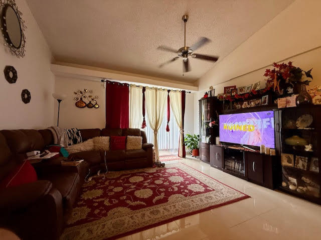 741 Lyons Road, Unit 17201 Coconut Creek, FL 33063 - Photo 11 of 45 a living room with furniture and a flat screen tv