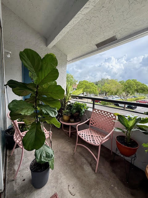 741 Lyons Road, Unit 17201 Coconut Creek, FL 33063 - Photo 12 of 45 a view of a chairs and table in a patio