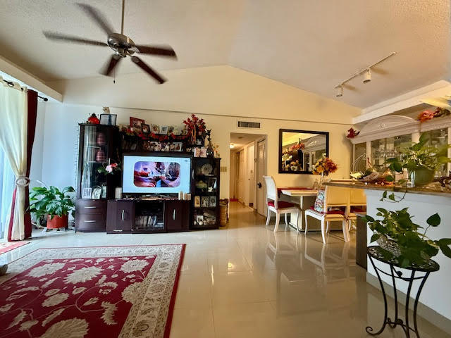 741 Lyons Road, Unit 17201 Coconut Creek, FL 33063 - Photo 14 of 45 a living room with furniture and a flat screen tv