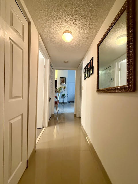 741 Lyons Road, Unit 17201 Coconut Creek, FL 33063 - Photo 15 of 45 a view of hallway with livingroom and furniture