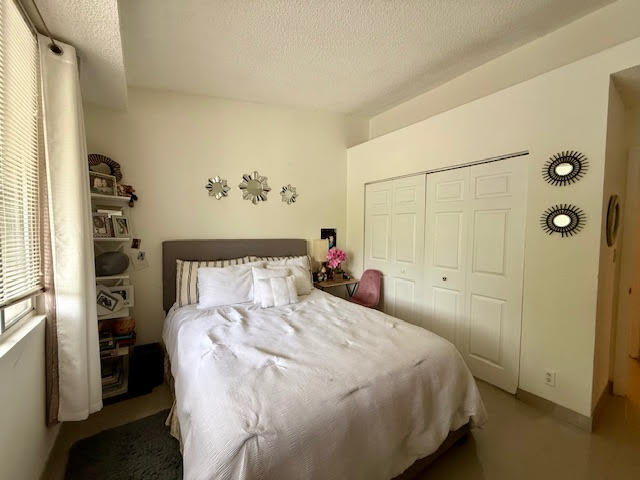 741 Lyons Road, Unit 17201 Coconut Creek, FL 33063 - Photo 20 of 45 a bedroom with a bed and a window