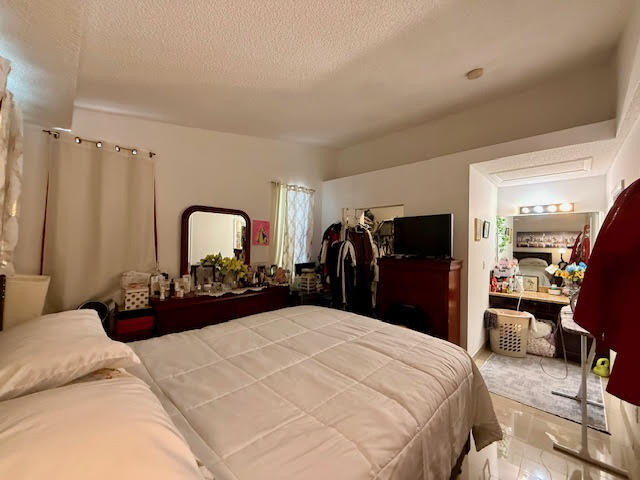 741 Lyons Road, Unit 17201 Coconut Creek, FL 33063 - Photo 30 of 45 a large bed in a bedroom and a large mirror