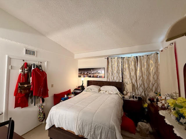 741 Lyons Road, Unit 17201 Coconut Creek, FL 33063 - Photo 31 of 45 a bed room with a bed and a walk in closet