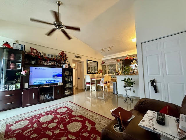 741 Lyons Road, Unit 17201 Coconut Creek, FL 33063 - Photo 33 of 45 a living room with furniture and a flat screen tv