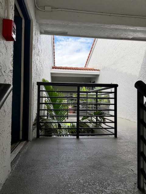741 Lyons Road, Unit 17201 Coconut Creek, FL 33063 - Photo 34 of 45 a view of room with stairs and a window
