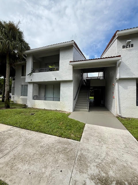 741 Lyons Road, Unit 17201 Coconut Creek, FL 33063 - Photo 35 of 45 a view of a house with a yard