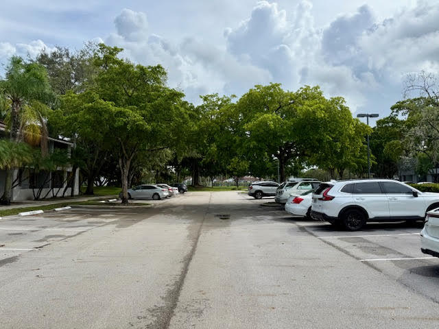 741 Lyons Road, Unit 17201 Coconut Creek, FL 33063 - Photo 36 of 45 a view of street with parked cars