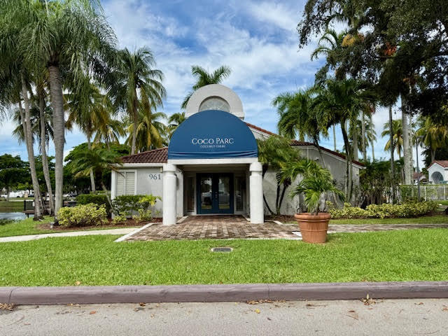 741 Lyons Road, Unit 17201 Coconut Creek, FL 33063 - Photo 41 of 45 a front view of a house with a garden