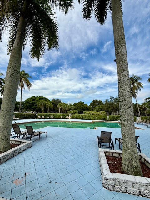 741 Lyons Road, Unit 17201 Coconut Creek, FL 33063 - Photo 42 of 45 a view of a terrace with a garden