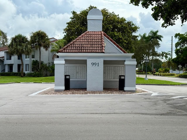 741 Lyons Road, Unit 17201 Coconut Creek, FL 33063 - Photo 43 of 45 a view of a house with a yard and large tree