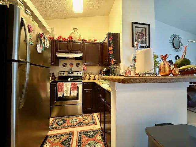 741 Lyons Road, Unit 17201 Coconut Creek, FL 33063 - Photo 9 of 45 a kitchen with a refrigerator and a stove