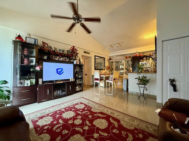 741 Lyons Road, Unit 17201 Coconut Creek, FL 33063 - Photo 10 of 45 a living room with furniture and a flat screen tv