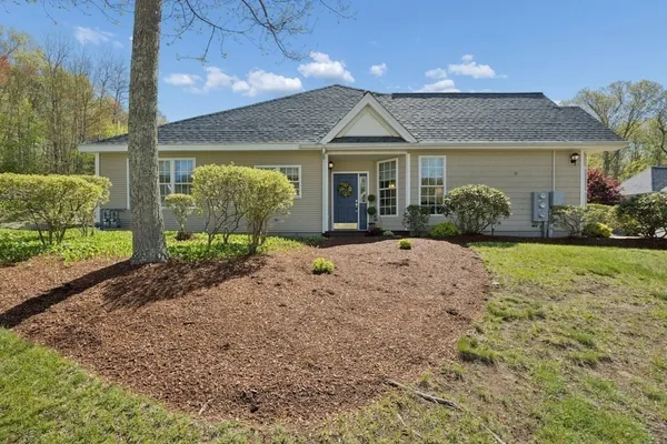 a front view of a house with garden