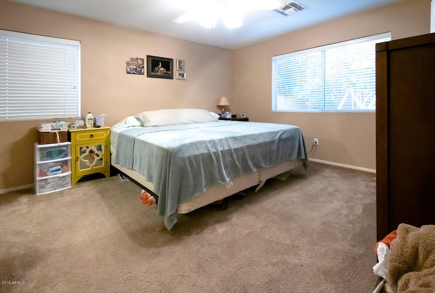 2908 East Harwell Road Gilbert, AZ 85234 - Photo 19 of 38 a spacious bedroom with a bed and a window