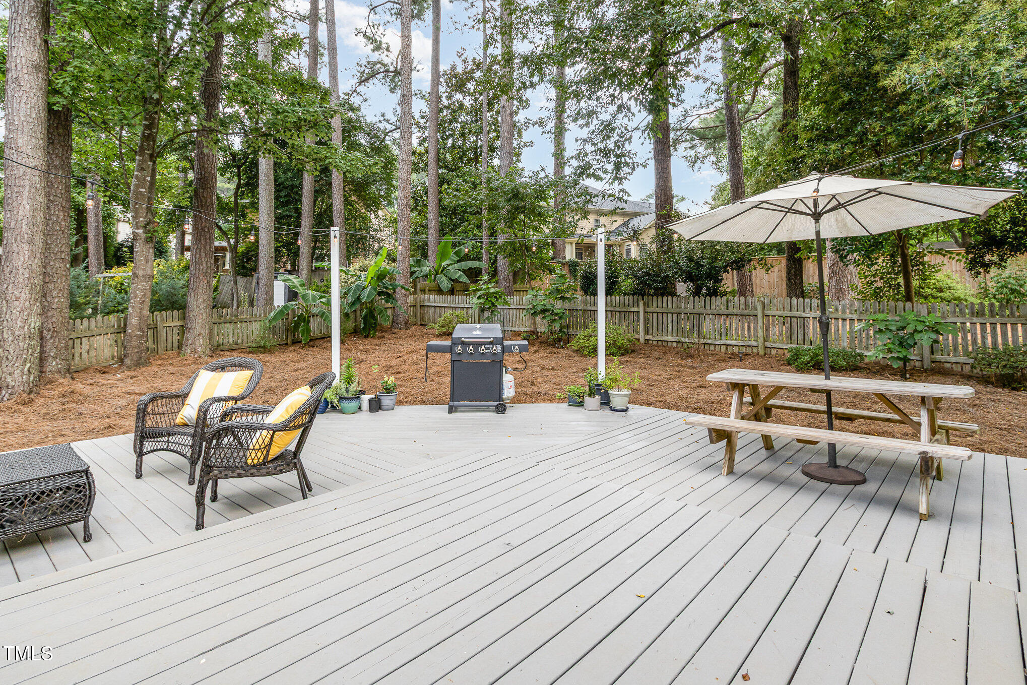 6025 Tarnhour Court Raleigh, NC 27612 - Photo 10 of 27 an outdoor sitting area with couch and umbrella