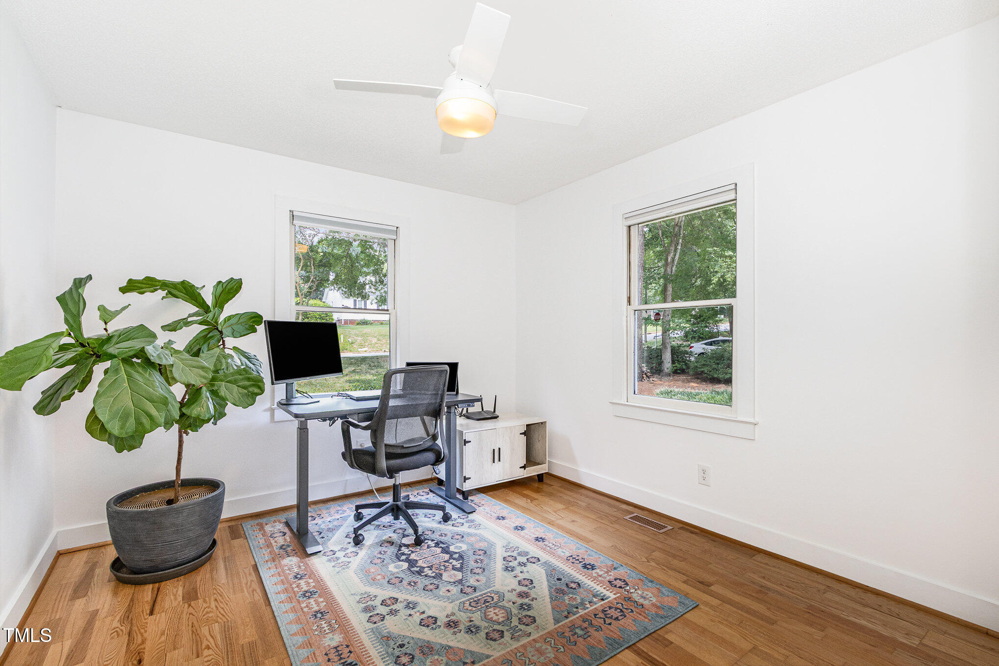 6025 Tarnhour Court Raleigh, NC 27612 - Photo 26 of 27 a living room with furniture and a potted plant