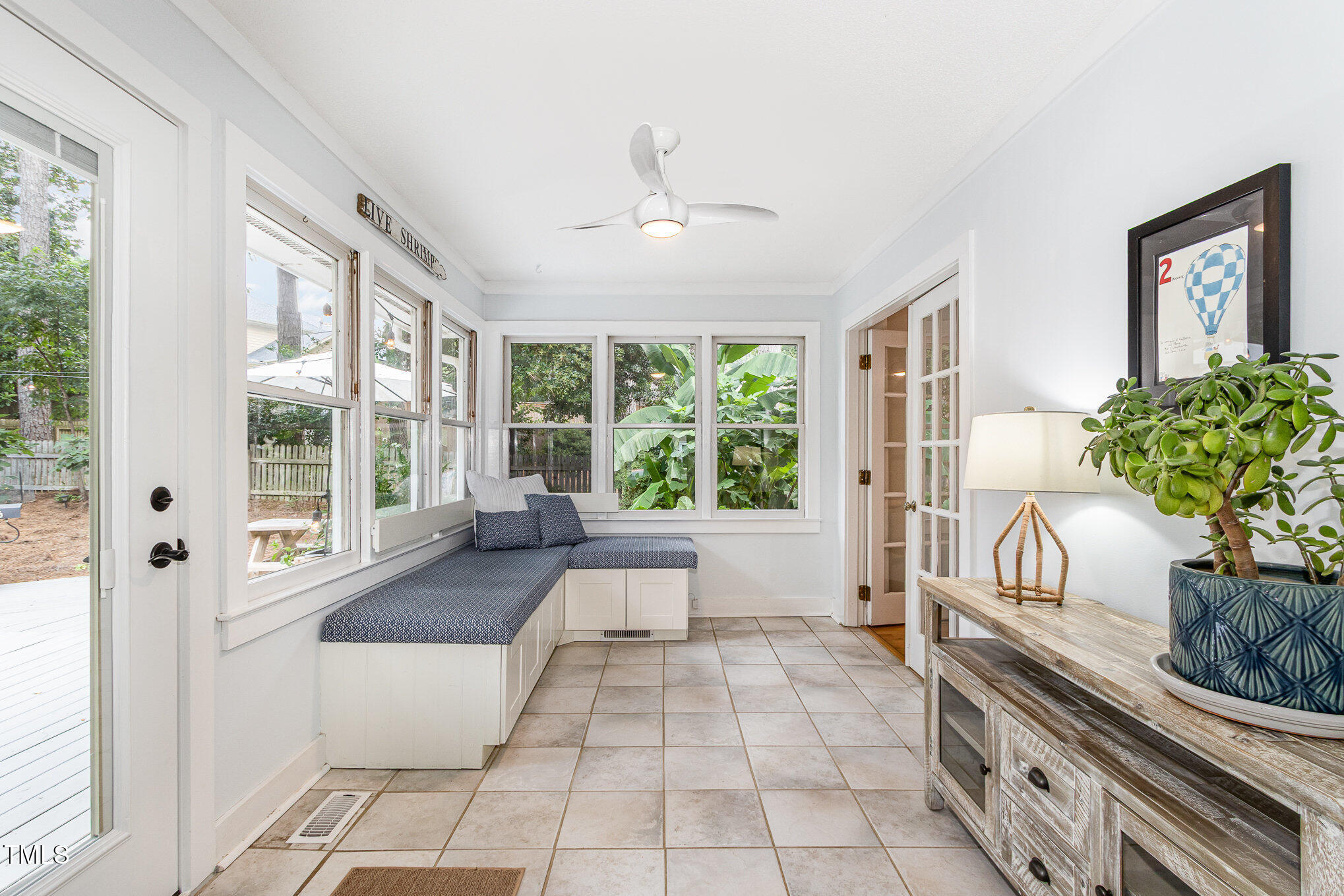 6025 Tarnhour Court Raleigh, NC 27612 - Photo 4 of 27 a spacious bedroom with a large window and chandelier