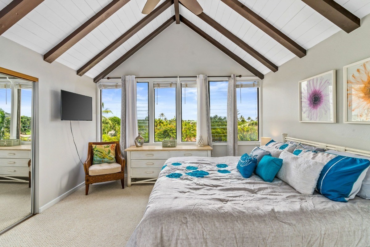 2370 Ho'ohu Road, Unit 522 Koloa, HI 96756 - Photo 17 of 29 a bed sitting in a bedroom next to a window
