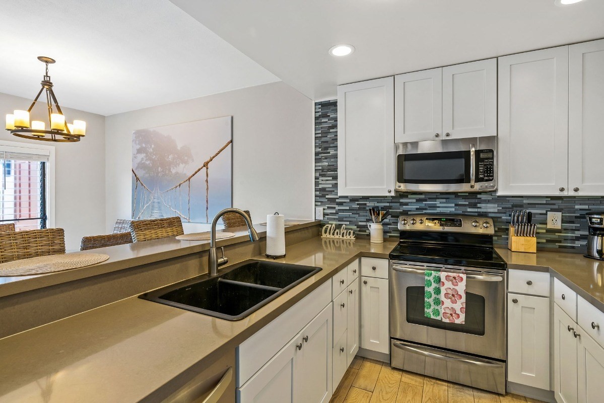 2370 Ho'ohu Road, Unit 522 Koloa, HI 96756 - Photo 5 of 29 a kitchen with a sink stove and microwave