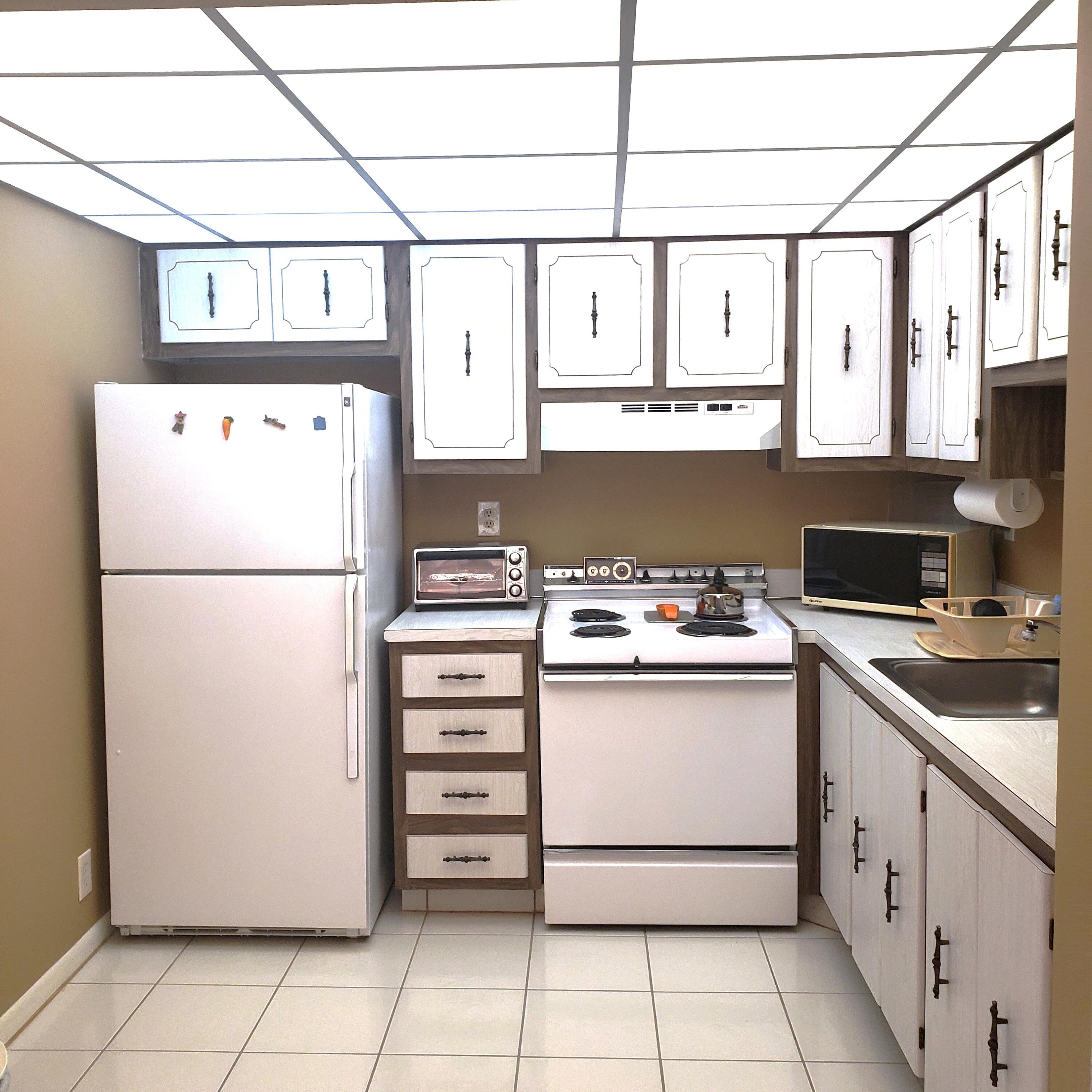 a kitchen with appliances cabinets and utility