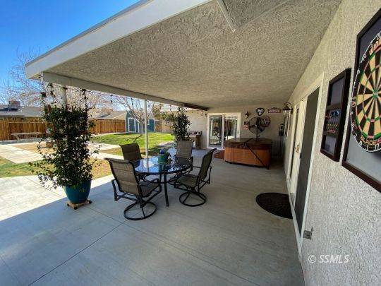 218 South Lilac Street Ridgecrest, CA 93555 - Photo 27 of 43 a dining room with furniture and a floor to ceiling window