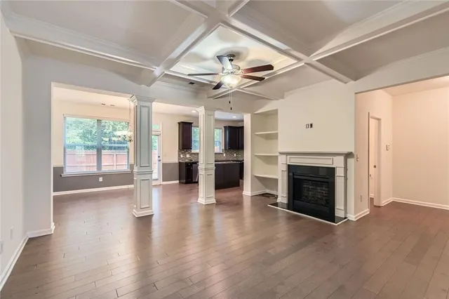 a view of an empty room with a fireplace and a window