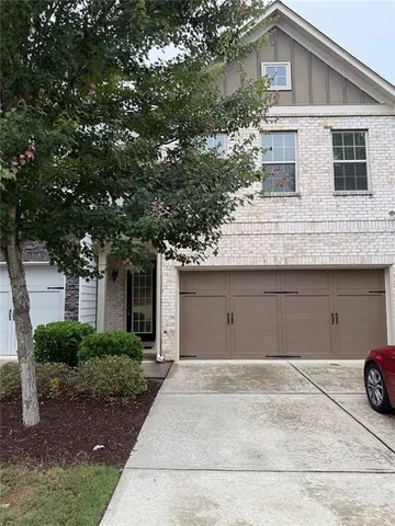 a front view of a house with garage