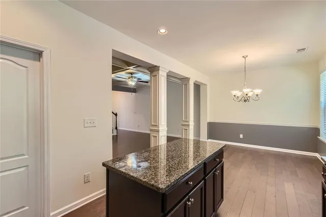 a kitchen with stainless steel appliances granite countertop a sink and a granite counter tops