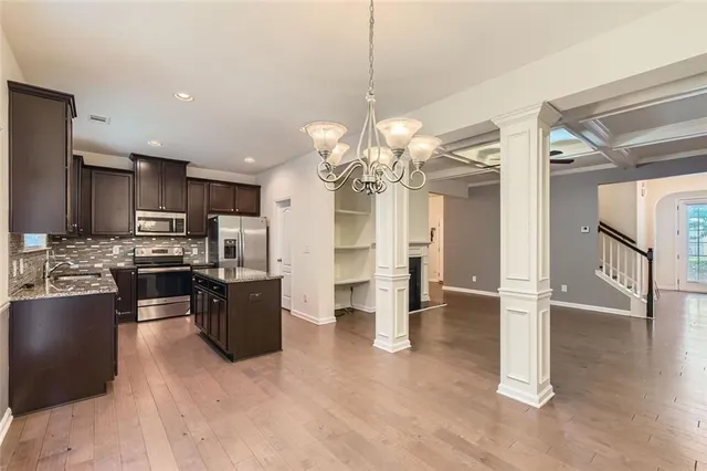 a view of a kitchen with refrigerator and cabinets