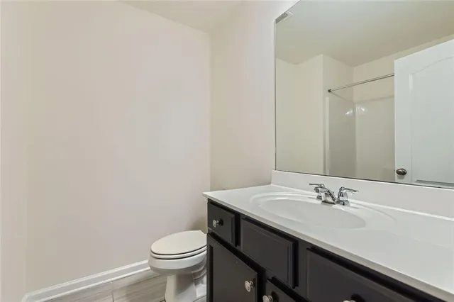 a bathroom with a sink a toilet and a mirror