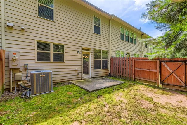a view of a backyard with chairs and a barn