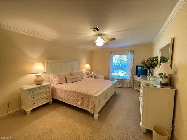 a bedroom with a large bed and a flat screen tv