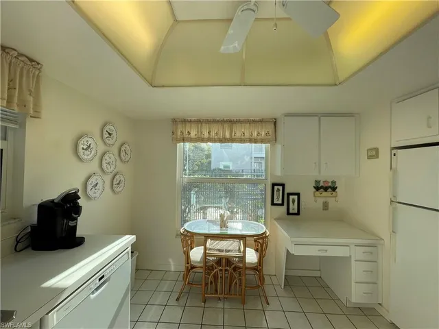 a view of a livingroom with furniture and a large window