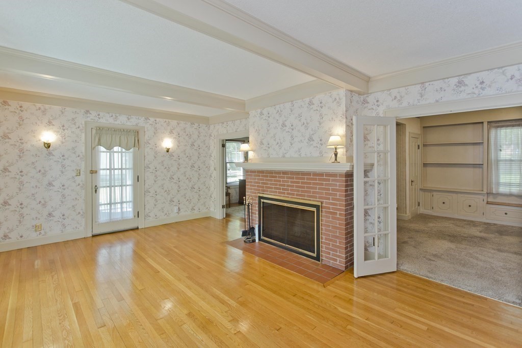 144 Pasco Road Springfield, MA 01151 - Photo 17 of 42 a view of an empty room with wooden floor fireplace and a window