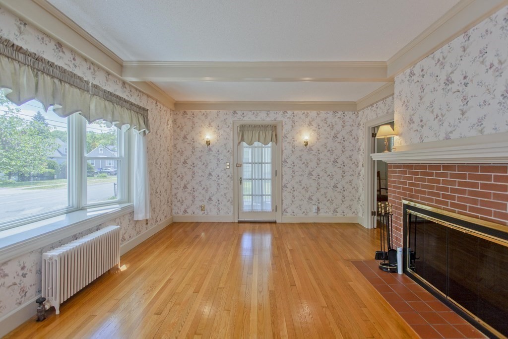 144 Pasco Road Springfield, MA 01151 - Photo 18 of 42 a view of empty room with wooden floor and fireplace