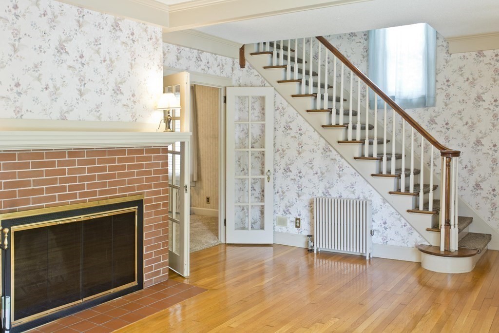 144 Pasco Road Springfield, MA 01151 - Photo 19 of 42 a view of an empty room with wooden floor and a fireplace